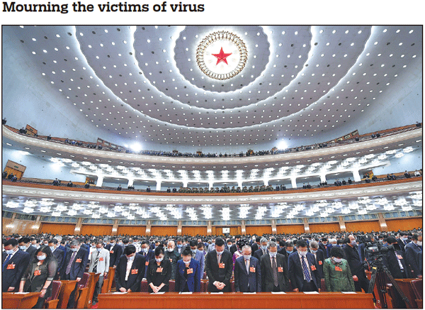 Members of the 13th National Committee of the Chinese People's Political Consultative Conference pause for one minute of mourning for the front-line workers and other compatriots who died from COVID-19, at the opening meeting of the third session of the 13th CPPCC National Committee at the Great Hall of the People in Beijing on Thursday. The opening raised the curtain on the two sessions, China's biggest annual political event. Yan Yan / Xinhua