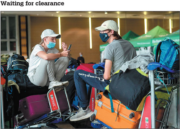 Students from Norway who were on a field trip to South Africa wait to be tested for COVID-19 before boarding a flight at Johannesburg's OR Tambo International Airport on Monday. The World Health Organization has urged countries around the world not to impose flight bans on southern African nations due to concern over the new Omicron variant.Jerome Delay/ap