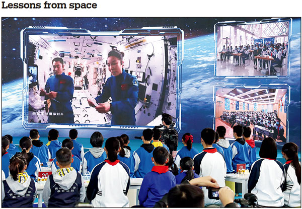 Chinese astronauts Wang Yaping (right) and Ye Guangfu give a livestreamed science lecture on Wednesday, the second class delivered from China's space station, as students at the China Science and Technology Museum in Beijing watch. Shenzhou XIII crew members Zhai Zhigang, Wang and Ye conducted scientific experiments in zero-gravity and introduced facilities on the space station during the lecture. HU LANYUE/FOR CHINA DAILY See story, page 3
