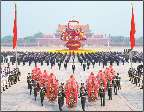 President Xi Jinping and other leaders of the Communist Party of China and the State pay tribute to fallen national heroes at Tian'anmen Square in Beijing on Friday.     Huang Jingwen / Xinhua