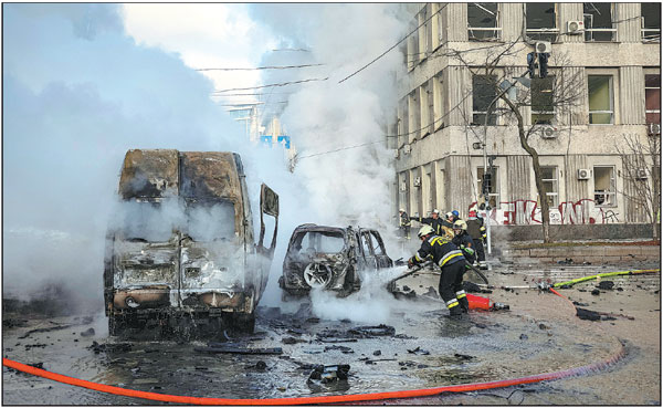 Vehicles burn on Monday in central Kyiv, Ukraine, after Russia launched targeted missile strikes on the city. The Kremlin said on Monday that the strikes were part of its special military operation. The strikes were seen as Russia's response to the explosion on a key bridge linking Russia to Crimea over the weekend.     Gleb Garanich / Reuters