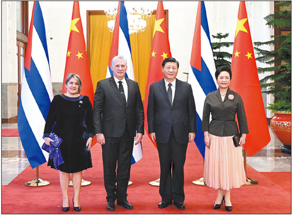 President Xi Jinping and his wife Peng Liyuan take a group photo with Cuban leader Miguel Diaz-Canel Bermudez and his wife Lis Cuesta at the Great Hall of the People in Beijing on Friday. SHEN HONG/XINHUA