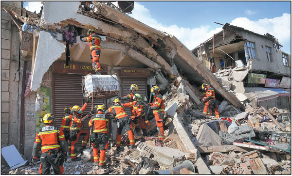 Rescue workers from Hong Kong search for survivors on Saturday in the rubble of collapsed buildings in the southern province of Hatay, Turkiye. Two powerful earthquakes jolted Turkiye and neighboring Syria on Feb 6, followed by multiple aftershocks. By Sunday, the death toll in the two countries had surpassed 33,000.      Hussein Malla / AP