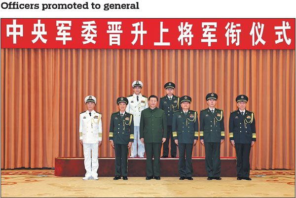 Xi Jinping, chairman of the Central Military Commission, poses for a group photo on Thursday with other military leaders and two military officers who were promoted to the rank of general. During the ceremony, Xi presented certificates of order to promote the two officers, Wang Renhua (back, left), secretary of the Commission for Political and Legal Affairs of the CMC, and Xiao Tianliang (back, right), president of the University of National Defense. Zhang Youxia (front, third from right), vice-chairman of the CMC, announced the order of promotion, which was signed by Xi. He Weidong (front, second from left), also CMC vice-chairman, presided over the ceremony.Li Gang/Xinhua