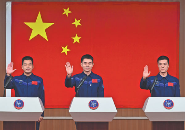 Crew members of the Shenzhou XVIII mission Ye Guangfu (center), Li Cong (right) and Li Guangsu meet the media at a news conference at the Jiuquan Satellite Launch Center on Wednesday.Wang Jiangbo/For China Daily