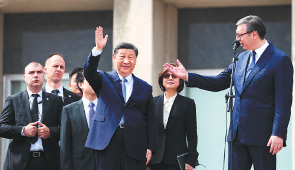 President Xi Jinping waves as Serbian President Aleksandar Vucic introduces him to the crowd at the Palace of Serbia in Belgrade on Wednesday during Xi's two-day state visit to Serbia.Djordje Kojadinovic/Reuters