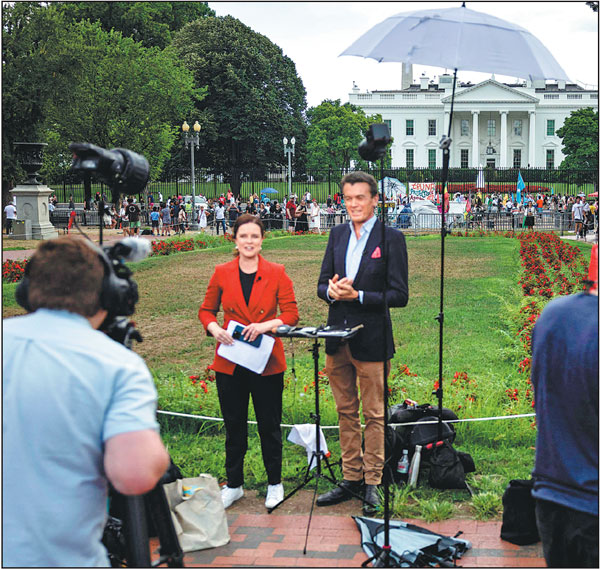 Journalists report from outside the White House in Washington, DC, on Sunday after United States President Joe Biden announced that he will not be seeking reelection. Biden's historic decision pushes the already turbulent 2024 race to the White House into uncharted territory. Biden said he was endorsing Vice-President Kamala Harris as the Democratic nominee for the 2024 election after dropping out of the race.Samuel Corum/Afp