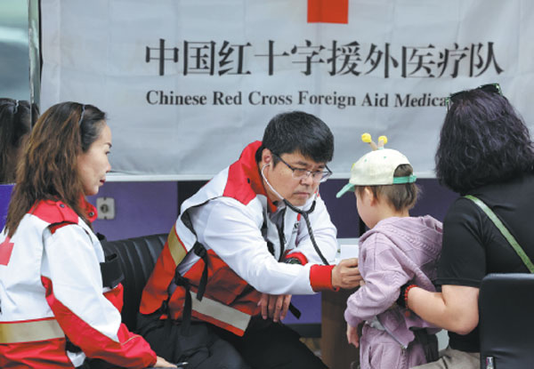 A doctor with the Chinese Red Cross foreign aid medical team checks the health of a child at a hospital in Ulaanbaatar, the capital of Mongolia, on Sept 24. The team was conducting a medical aid program to screen local children for congenital heart disease.Tao Ran/For China Daily
