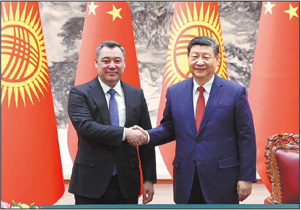 President Xi Jinping shakes hands with Kyrgyz President Sadyr Japarov in Beijing on Wednesday. WANG ZHUANGFEI/CHINA DAILY