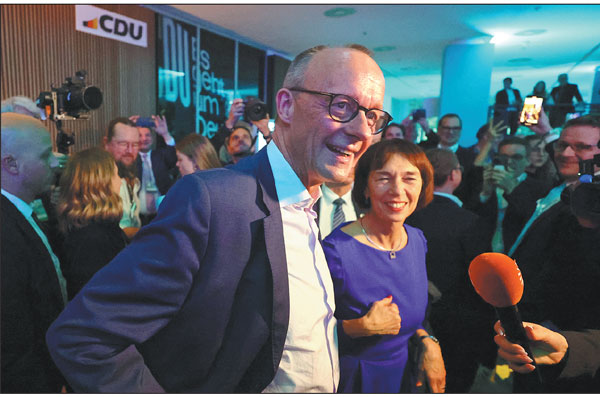 Germany's conservative opposition leader Friedrich Merz, accompanied by his wife Charlotte Merz, speaks to the media on Sunday in Berlin, Germany, after provisional results handed him victory in the country's national elections.Fabrizio Bensch/Reuters