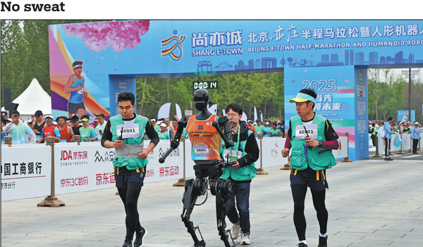 Tiangong Ultra, a humanoid robot from the Beijing Innovation Center of Human Robotics, competes in the Humanoid Robot Half Marathon in Beijing on Saturday along with its human navigators. The robot, which won the race, completed the run in 2 hours, 40 minutes and 42 seconds as the world's first humanoid robot to finish a half-marathon. Wang Jing/China Daily