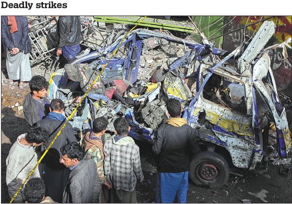 Local residents inspect a vehicle damaged by US airstrikes at Farwah market in Sanaa, Yemen, on Monday. The airstrikes targeting Yemen's capital killed 12 people and wounded 30 others, the Houthis said.Ap