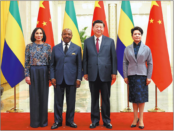 President Xi Jinping and his wife, Peng Liyuan, pose for a photograph with Gabonese President Ali Bongo Ondimba and his wife, Sylvia Bongo Ondimba, in the Great Hall of the People in Beijing on Wednesday. FENG YONGBIN/CHINA DAILY