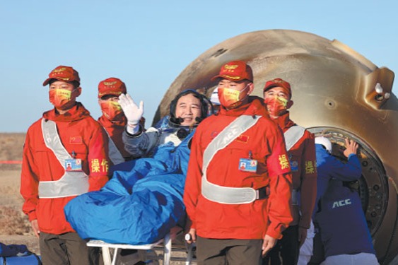 Major General Jing Haipeng, commander of the Shenzhou XVI manned space mission, waves on Tuesday after disembarking from the reentry capsule at the Dongfeng Landing Site in the Inner Mongolia autonomous region. Jing and his team members, Colonel Zhu Yangzhu and Professor Gui Haichao, completed their five-month mission at the Tiangong space station.Zhu Xingxin/China Daily