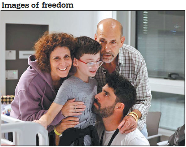 Nine-year-old Ohad Monder meets his father, brother and another family member on Saturday at the Schneider Children's Medical Center of Israel in Petach Tikvah, Israel. Ohad Monder was reunited with his family after being held captive for 49 days by Hamas in Gaza.       Schneider Children's Medical Center Spokesperson via AP