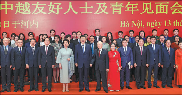 Xi Jinping (center), general secretary of the Communist Party of China Central Committee and Chinese president, and his wife, Peng Liyuan, join General Secretary of the Communist Party of Vietnam Central Committee Nguyen Phu Trong and his wife, Ngo Thi Man, to pose for a group photo in Hanoi, Vietnam, on Wednesday with representatives of youth and people who have contributed to bilateral friendship.Feng Yongbin/China Daily