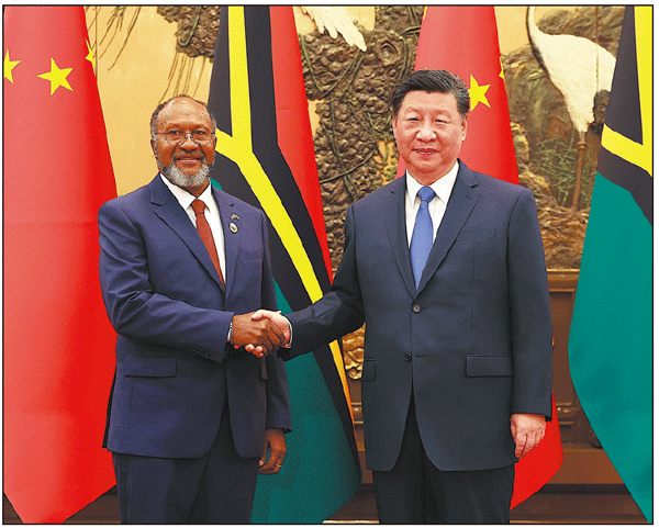 President Xi Jinping shakes hands with Prime Minister of the Republic of Vanuatu Charlot Salwai in Beijing on Friday. FENG YONGBIN/CHINA DAILY