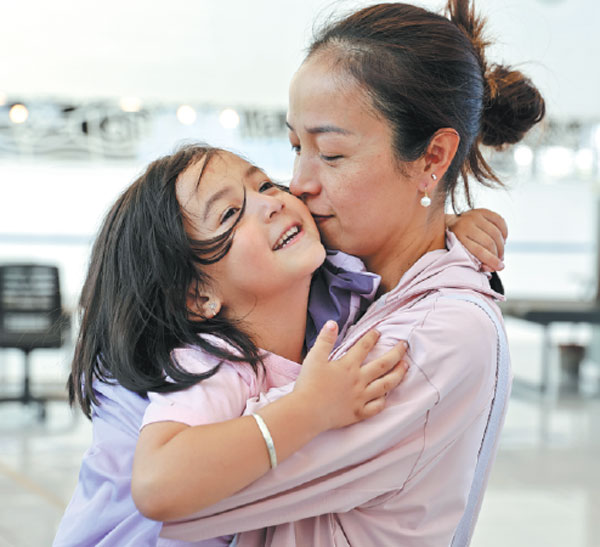 A mother-daughter duo evacuated from Lebanon share a tender moment at Limassol Port in Cyprus on Tuesday. They were part of a group of 80 people, including 69 Chinese nationals, who left Lebanon by ship. China has evacuated over 200 of its citizens from Lebanon amid escalating tensions in the Middle East.Li Jing/Xinhua