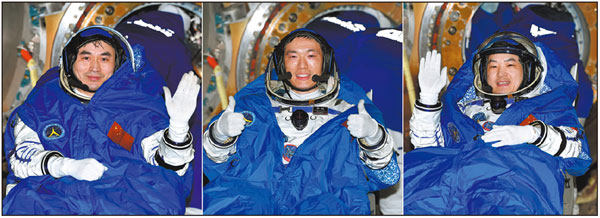 Shenzhou XVIII mission commander Senior Colonel Ye Guangfu (left) and crew members Lieutenant Colonel Li Cong (middle) and Lieutenant Colonel Li Guangsu wave and cheer during a live program early Monday morning soon after the spaceship's reentry capsule touched down at the Dongfeng Landing Site in the Inner Mongolia autonomous region. WANG JIANGBO/FOR CHINA DAILY
