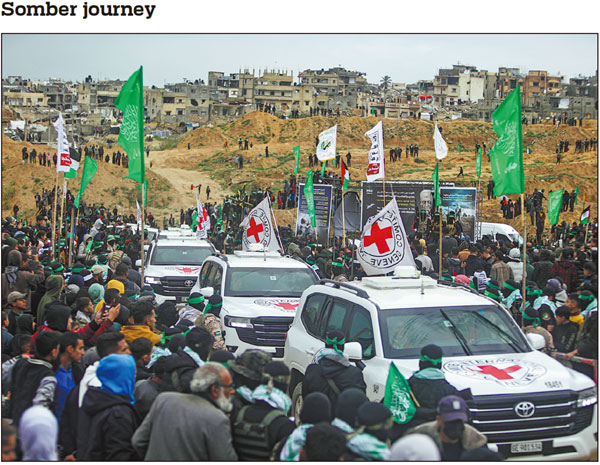 Red Cross vehicles arrive in Khan Younis in the southern Gaza Strip to collect coffins containing the bodies of four Israeli hostages to be handed over by Palestinian militant groups on Thursday. JEHAD ALSHRAFI/AP See story, page 6