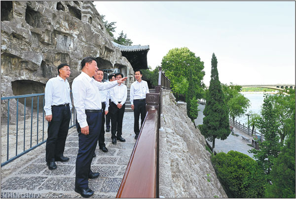 President Xi Jinping, who is also general secretary of the Communist Party of China Central Committee and chairman of the Central Military Commission, visits the Longmen Grottoes on Monday during his inspection of Luoyang, Henan province. During the visit, Xi learned about local efforts to enhance the protection and utilization of historical and cultural heritage, and promote the high-quality development of the cultural and tourism sector.Xie Huanchi/Xinhua