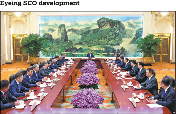 President Xi Jinping (center) meets on Tuesday in Beijing with foreign ministers and heads of standing bodies of the Shanghai Cooperation Organization, who are in China to attend the Meeting of the Council of the Ministers of Foreign Affairs of SCO Member States. Xi noted that over the past 24 years since its founding, the SCO has always upheld the Shanghai Spirit, grown into a mature and robust organization, and demonstrated strong vitality. China announced on Tuesday that the SCO Tianjin Summit will be held from Aug 31 to Sept 1.Feng Yongbin/China Daily
